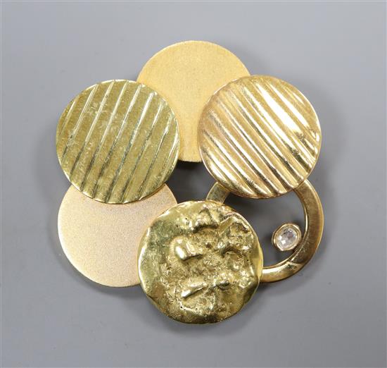 A yellow metal multiple disc brooch (tests as 18ct) set with a single diamond, gross 24.9g, 46mm.